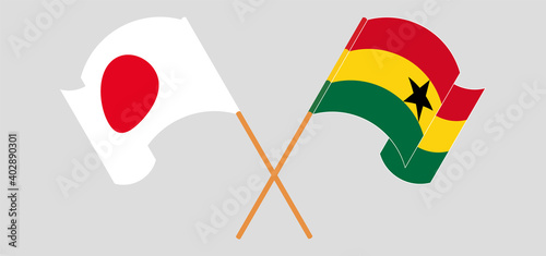 Crossed and waving flags of Japan and Ghana
