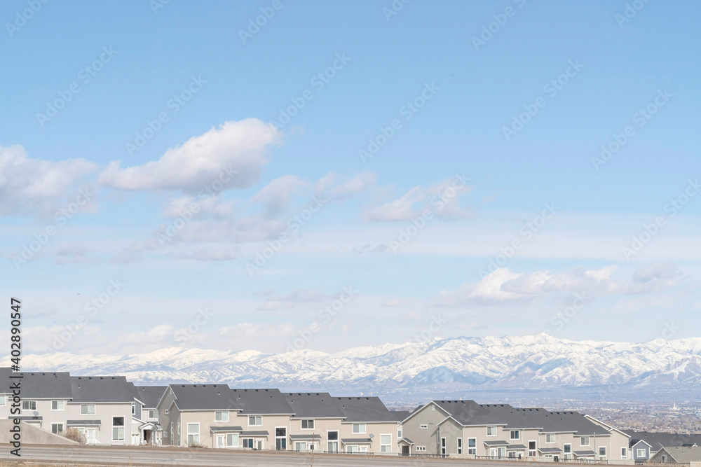 Neighborhood views with homes overlooking scenic skyscape and snowy mountain