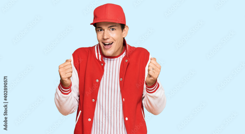 Handsome caucasian man wearing baseball uniform celebrating surprised and amazed for success with arms raised and open eyes. winner concept. Handsome caucasian man wearing baseball uniform celebrating surprised and amazed for success with arms raised and open eyes. winner concept.