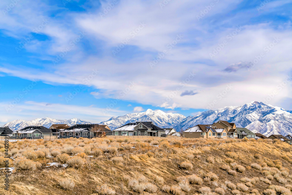 Homes on sweeping grassy terrain with fantastic view of snowy Wasatch Mountains
