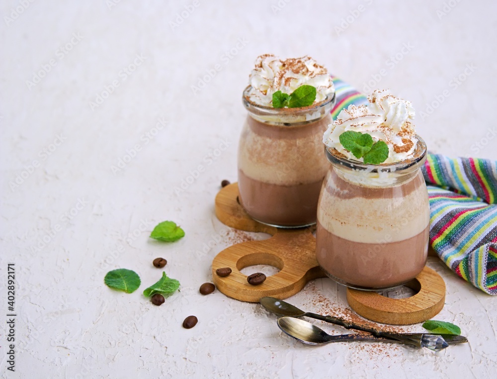Dessert, two-layer chocolate and coffee panna cotta, decorated with whipped cream. Dessert, two-layer chocolate and coffee panna cotta, decorated with whipped cream.
