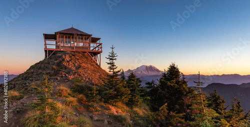 Panoramic view of a fire lookout with mt rainier in the background during the sunset photo
