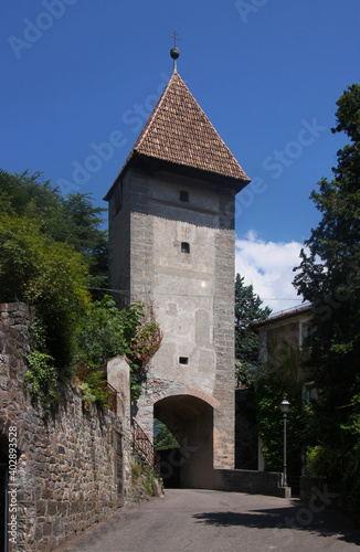 The medieval Passeirer Tor city gate with segmental arch in the old town of Merano in South Tyrol Italy