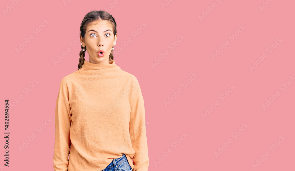 Beautiful caucasian woman with blonde hair wearing casual winter sweater afraid and shocked with surprise expression, fear and excited face. Beautiful caucasian woman with blonde hair wearing casual winter sweater afraid and shocked with surprise expression, fear and excited face.