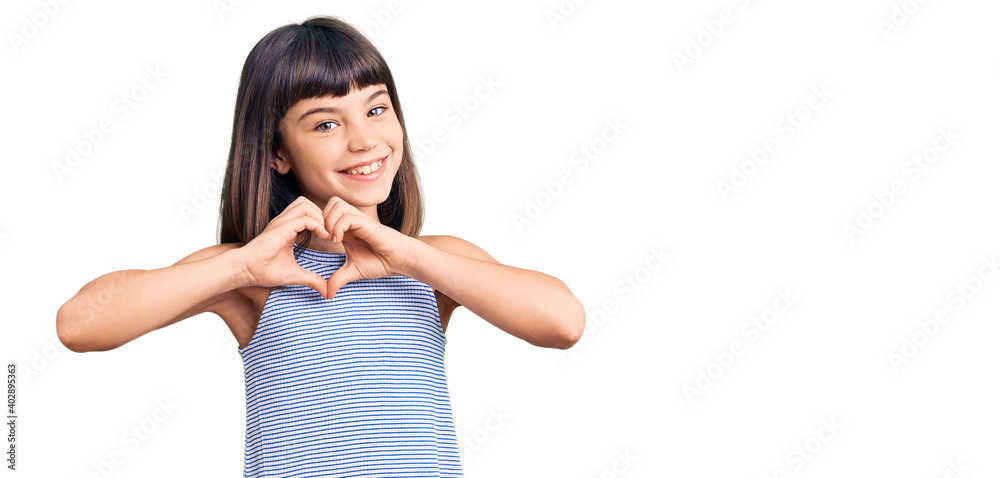 Young little girl with bang wearing casual clothes smiling in love showing heart symbol and shape with hands. romantic concept. Young little girl with bang wearing casual clothes smiling in love showing heart symbol and shape with hands. romantic concept.