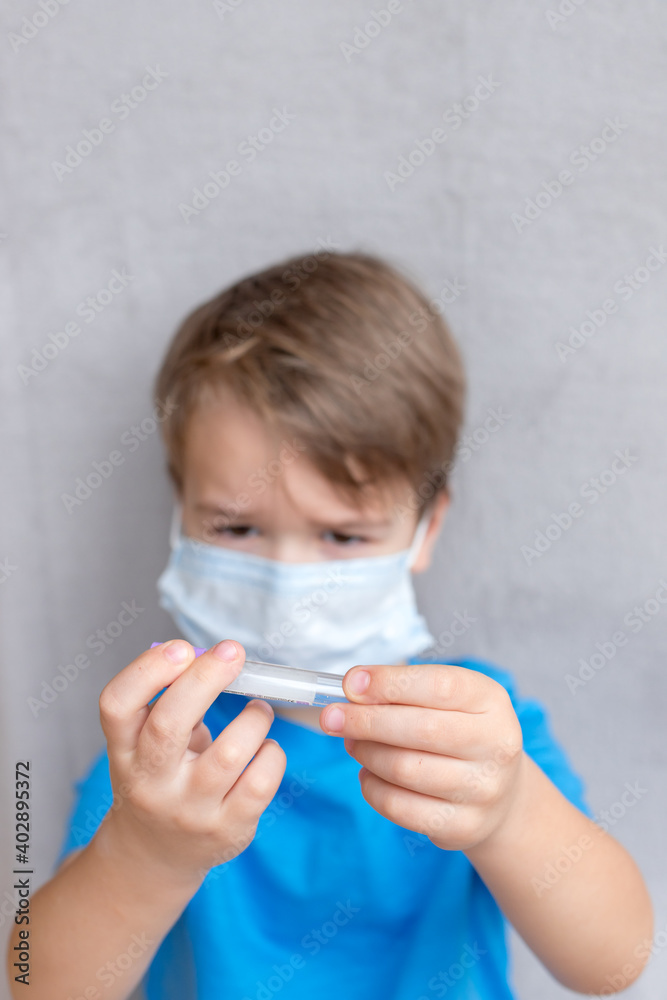 Portrait of Toddler kid wearing medical mask.A boy wearing mouth mask against air smog pollution. Concept of coronavirus quarantine or covid-19.
vaccine, antibodies, vaccinations, control concept. 
