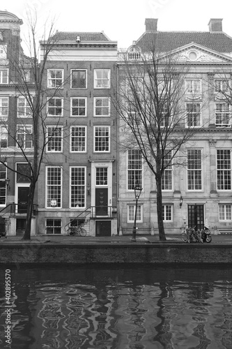 Street View Amsterdam Canal with Buildings and Winter Trees in Black and White