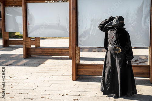 plague doctor stands at empty stands