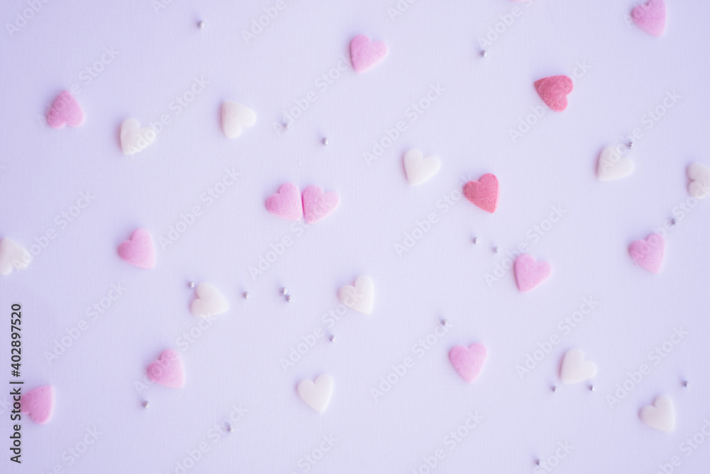Pink sprinkles background, sugar sprinkle hearts, decoration for cake and bakery. Top view, flat lay. pastel colors