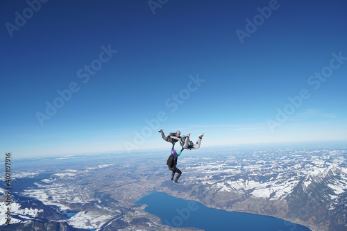 Skydivers perform stunts above snowcapped mountains © Talent for Adventure