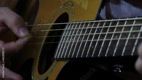 Young man playing acoustic guitar.