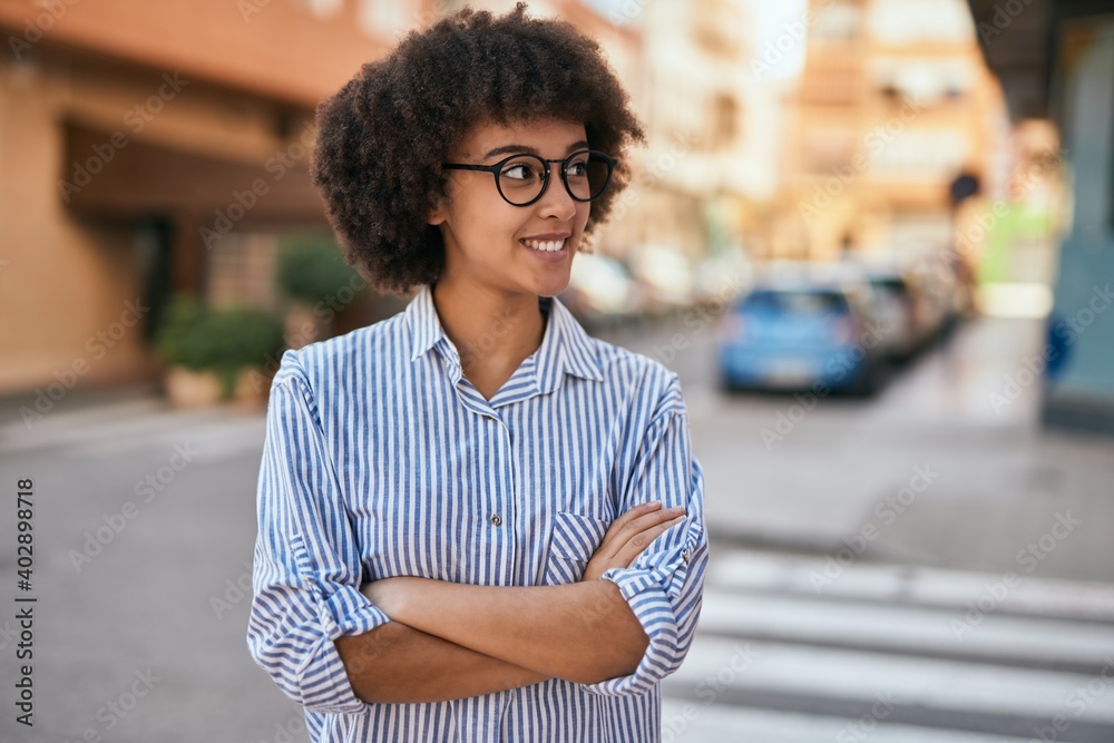 Young hispanic businesswoman with arms crossed smiling happy at the city. Young hispanic businesswoman with arms crossed smiling happy at the city.
