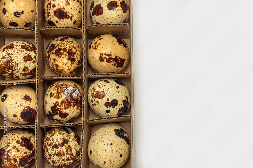 quail eggs in paper box on white background isolate close-up