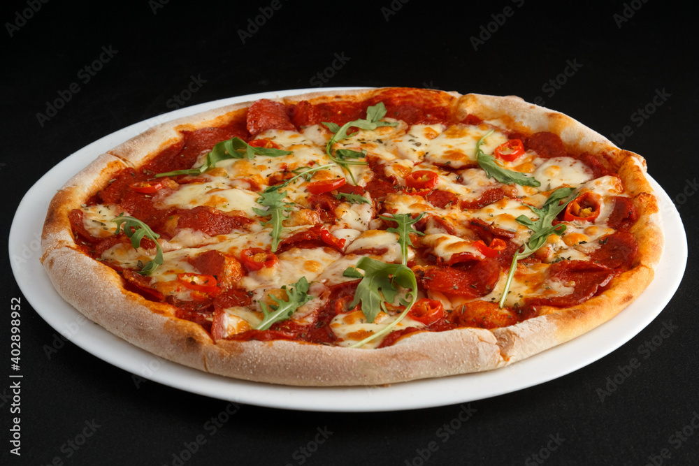 fragrant and hot pizza on a dark background fragrant and hot pizza on a dark background