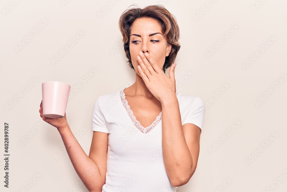 Young beautiful woman holding coffee covering mouth with hand, shocked and afraid for mistake. surprised expression Young beautiful woman holding coffee covering mouth with hand, shocked and afraid for mistake. surprised expression