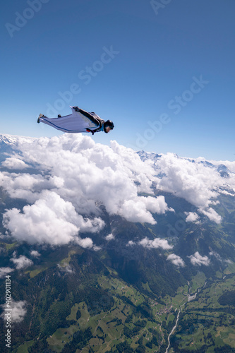 Wingsuit flier glides high above land © Talent for Adventure