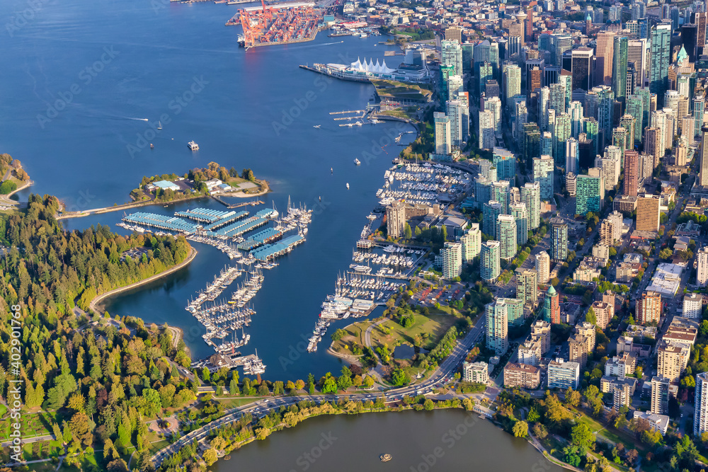 Naklejka premium Aerial view of Coal Harbour and a modern Downtown City during a vibrant sunny morning. Taken in Vancouver, British Columbia, Canada.