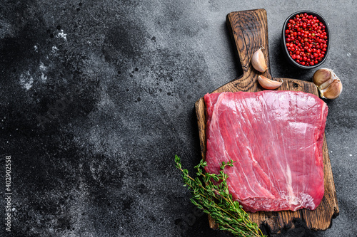 Fototapete Raw flank or flap beef meat steak on a wooden cutting board