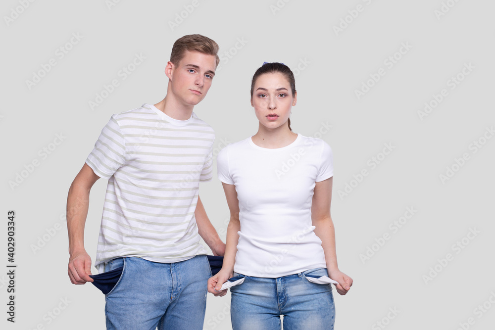 Couple Showing Empty Pockets. Family Budget. No Money, No Cash, Poor Concept. Couple Showing Empty Pockets. Family Budget. No Money, No Cash, Poor Concept.