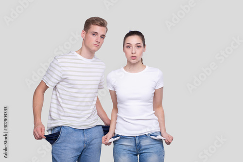 Couple Showing Empty Pockets. Family Budget. No Money, No Cash, Poor Concept.