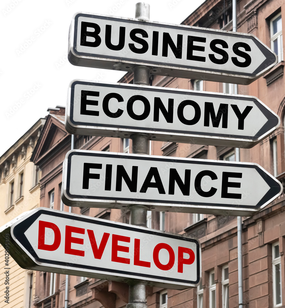 The road indicator on the arrows of which is written - business, economics, finance and DEVELOP The road indicator on the arrows of which is written - business, economics, finance and DEVELOP