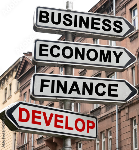 The road indicator on the arrows of which is written - business, economics, finance and DEVELOP