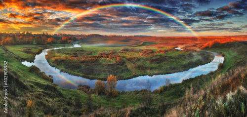 Fototapeta Naklejka Na Ścianę i Meble -  Amazing rainbow over the small rural river. autumn morning
