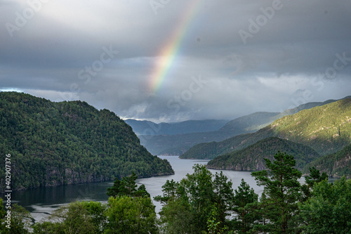 Rainbow comes out of a fjord in Norway
