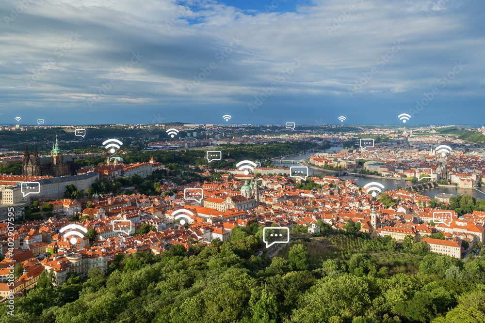 View of the Petrin Hill, Mala Strana (Lesser Town) and Old Town districts and beyond in Prague, Czech Republic, from above. Wireless network connection, WiFi, smart city and online messaging concept. 