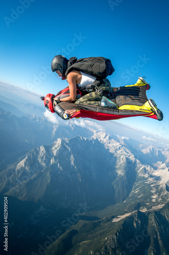 Tandem wingsuit fliers piggyback ride over mountains 