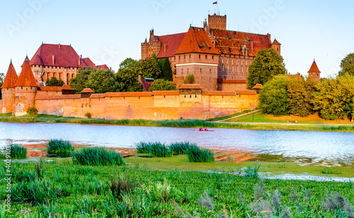 Panoramic view of the Teutonic Order Castle in Malbork during sunset.