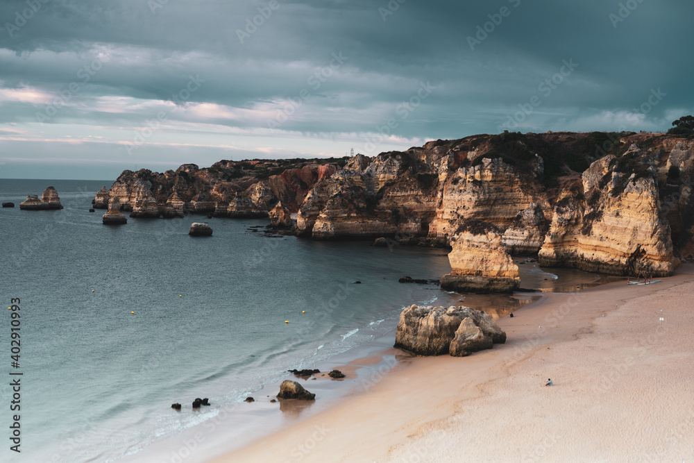 Early morning on the Algarve coast. Famous rocks and calm ocean. Turquoise color scheme. Lagos, Portugal