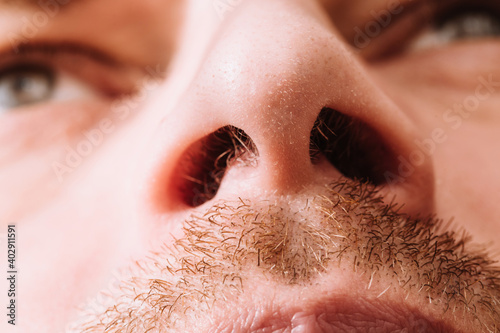 Tablou pe pânză Close up of nostrils and hair in them - male nose bottom view