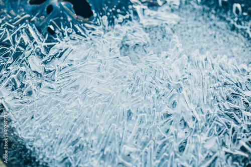 Blue azure ice crystals close up - close-up winter theme - ice crust in severe frost