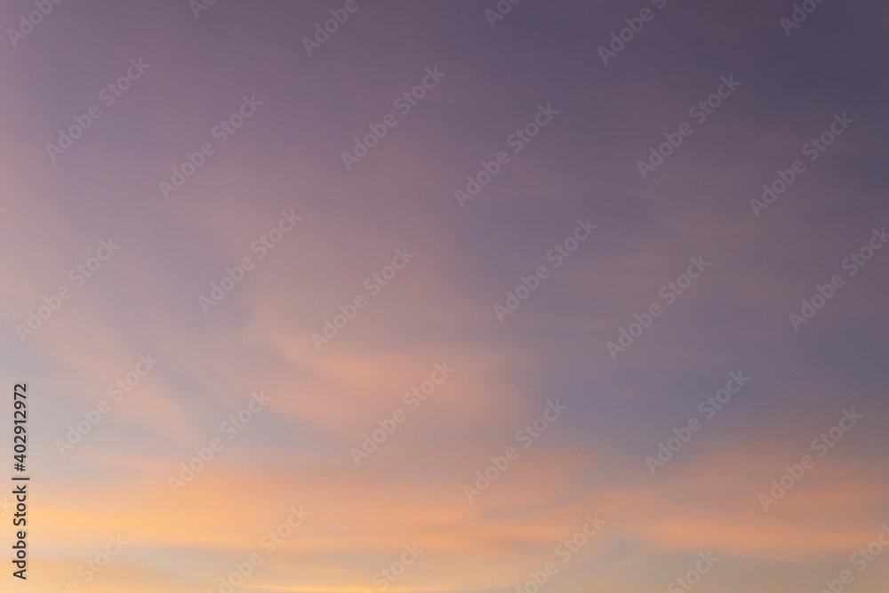 Blue sky with pink and yellow cirrus clouds just before sunset