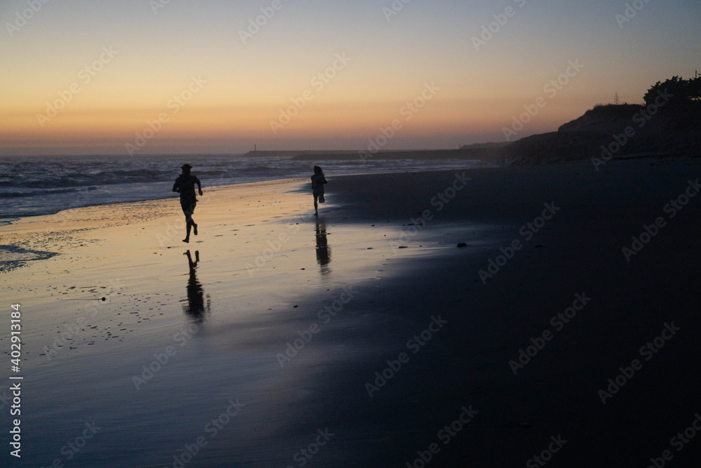 Kids running by the beach