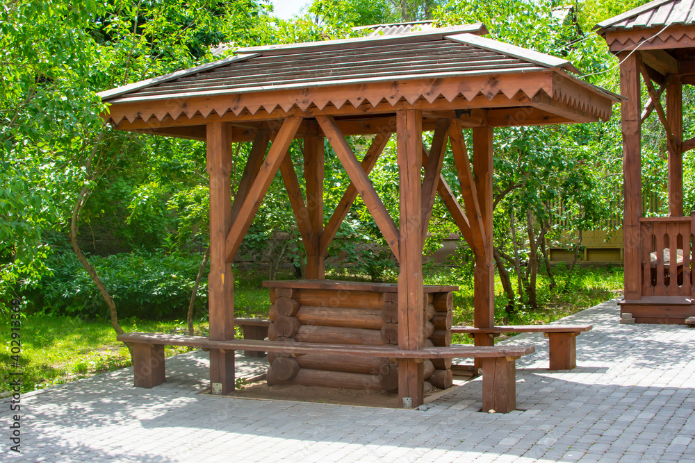 Naklejka premium Wooden water well in summer time. Village water well view. Rural water well