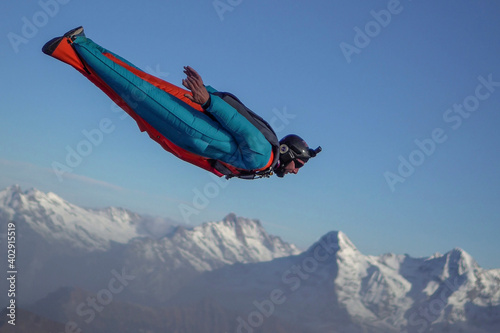 Wingsuit flier glides over Swiss Alps photo