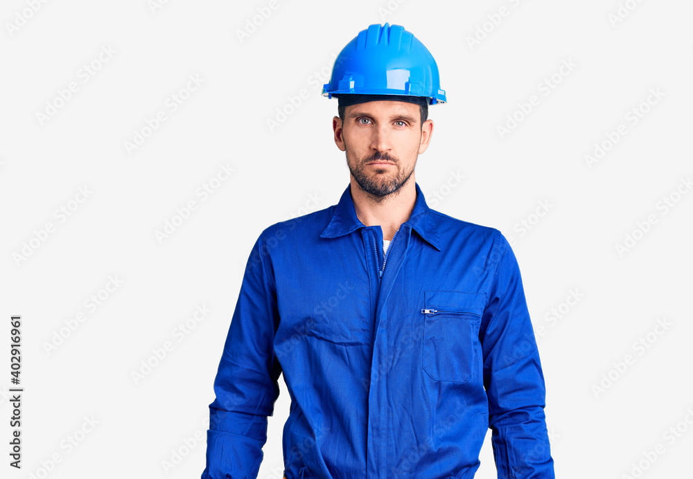 Young handsome man wearing worker uniform and hardhat tired rubbing nose and eyes feeling fatigue and headache. stress and frustration concept.