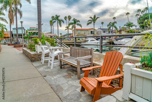 Chairs and benches along pathway and canal in Long Beach California neighborhood