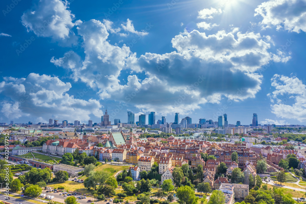 Aerial panorama of Warsaw, Poland  over the Vistula river and City center in a distance. Sky Clouds and sun