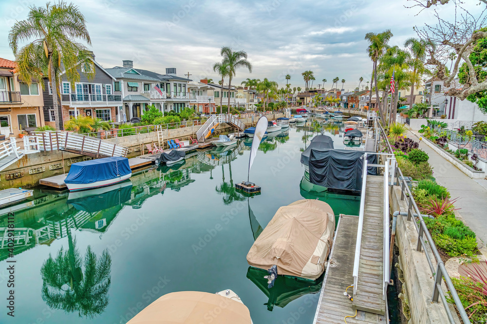 Boat docks and stairs at a calm canal in Long beach California neighborhood