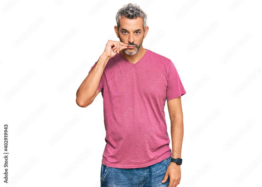Middle age grey-haired man wearing casual clothes mouth and lips shut as zip with fingers. secret and silent, taboo talking Middle age grey-haired man wearing casual clothes mouth and lips shut as zip with fingers. secret and silent, taboo talking