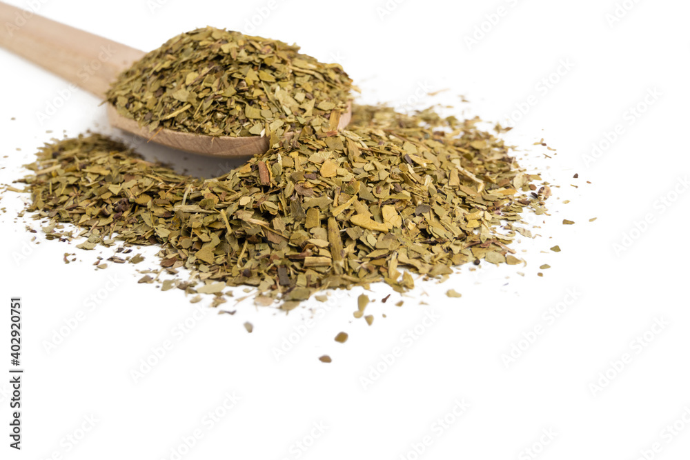 Dried leaves of yerba mate tea on wooden spoon isolated on white background. nutrition. Traditional tea in South-America. Dried leaves of yerba mate tea on wooden spoon isolated on white background. nutrition. Traditional tea in South-America.