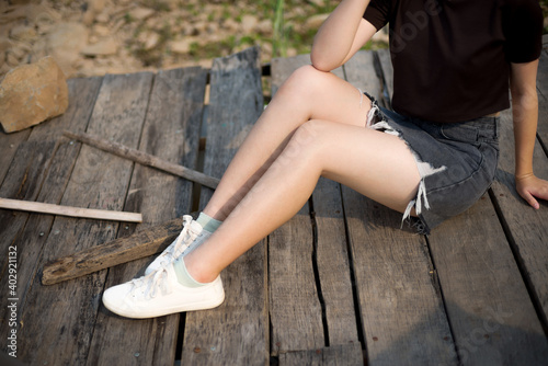 Young woman legs sitting on tropical vacation in asia.