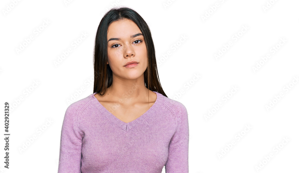Young hispanic girl wearing casual clothes relaxed with serious expression on face. simple and natural looking at the camera. Young hispanic girl wearing casual clothes relaxed with serious expression on face. simple and natural looking at the camera.