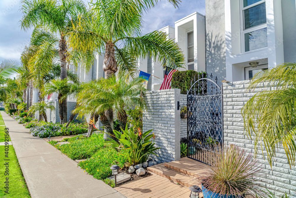 Modern townhomes with landscaped yards stone fence and wrought iron