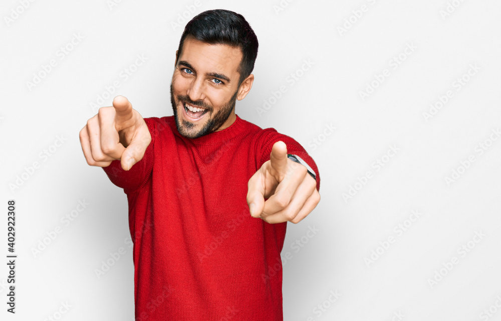 Young hispanic man wearing casual clothes pointing to you and the camera with fingers, smiling positive and cheerful - obrazy, fototapety, plakaty 