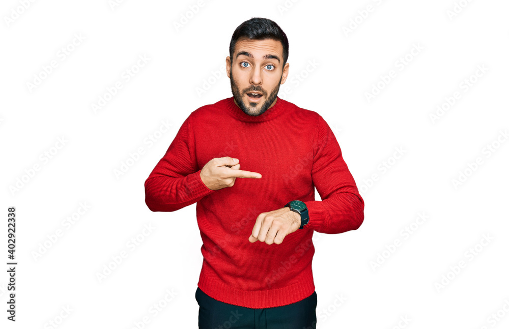 Young hispanic man wearing casual clothes in hurry pointing to watch time, impatience, upset and angry for deadline delay Young hispanic man wearing casual clothes in hurry pointing to watch time, impatience, upset and angry for deadline delay
