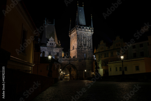 .bridge towers on Charles Bridge and street lights at night in Prague in the Czech Republic